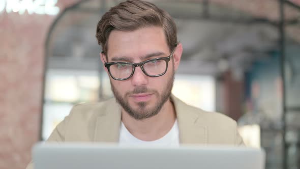 Close Up of Man with Laptop Sleeping