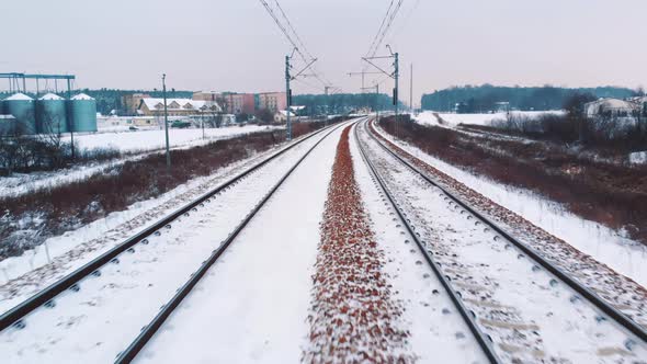 View From a Moving Train Over the Snow Covered Railroad