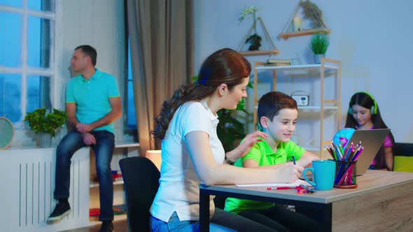 In a Modern Living Room Mother Doing the Home Work