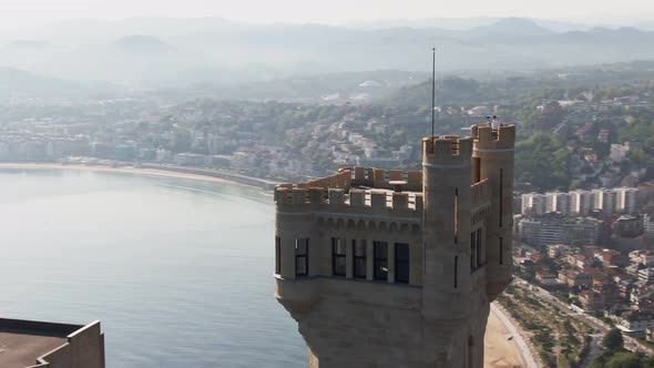 Majestic medieval tower and skyline of San Sebastian city, cinematic aerial view