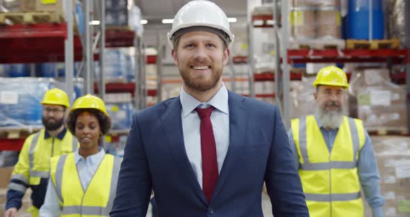 Multiethnic Team of Warehouse Workers Smiling at Camera