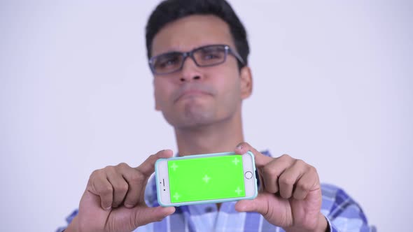 Face of Happy Young Indian Hipster Man Showing Phone