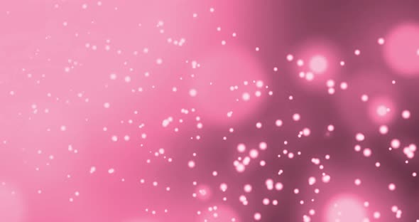 Animation of multiple glowing pink spots of light moving in hypnotic motion on pink background alt
