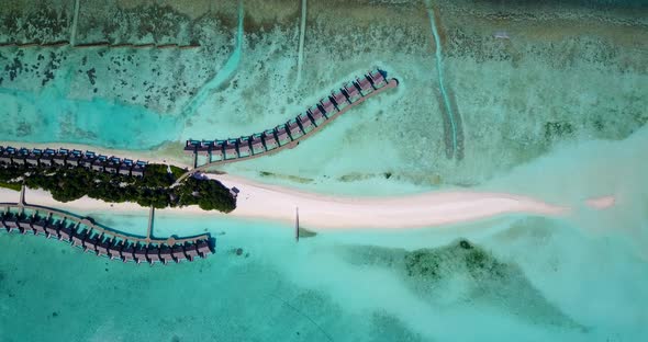 Wide angle aerial travel shot of a white sandy paradise beach and turquoise sea background in best 