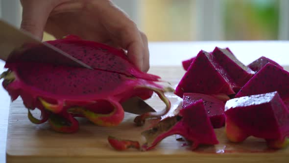 Chef cuts into pieces the tropical fruit pitahaya or dragon fruit, Thailand
