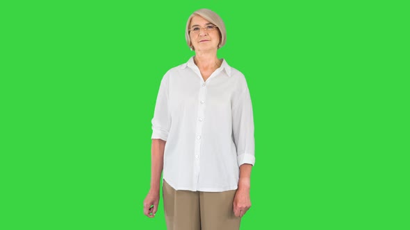 Happy Old Senior Woman Modern Grandma in Glasses Looking at Camera on a Green Screen Chroma Key