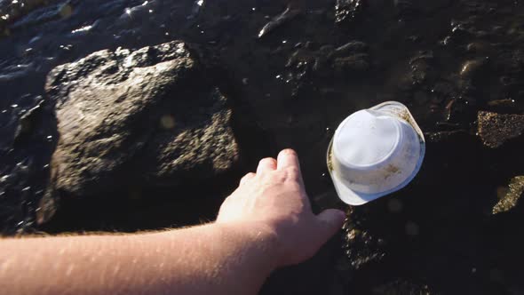 Man Collecting Plastic Litter on Shore