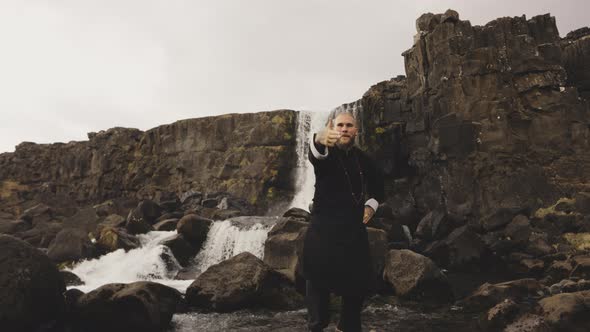 Kung Fu Master Dancing On Rocks By Waterfall