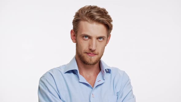 Sexy Caucasian Bearded Male with Blue Eyes and Brown Beard Ogles and Flirts on White Background