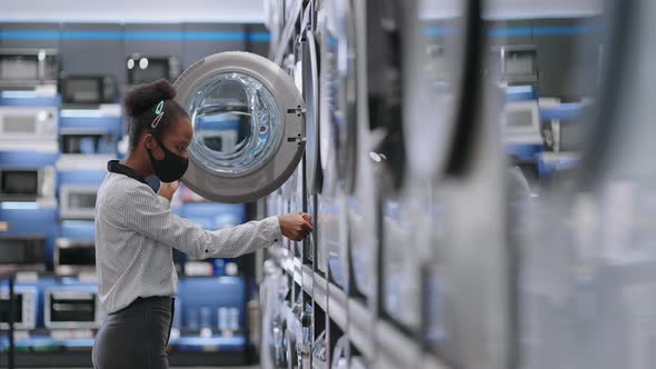 Young Black Woman is Choosing Washing Machine in Home Appliances Storefemale Shopper is Viewing