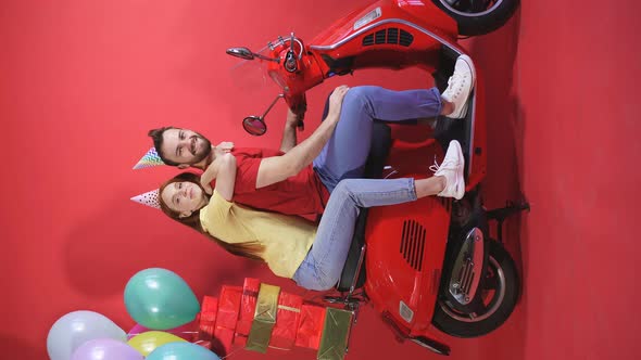 Happy Man and Woman Having Fun Young Couple on Scooter Isolated Background Holiday Balloons and