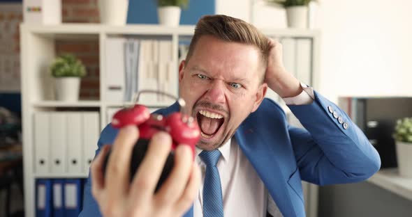 Businessman Looks at Red Alarm Clock in Horror and Shouts  Movie