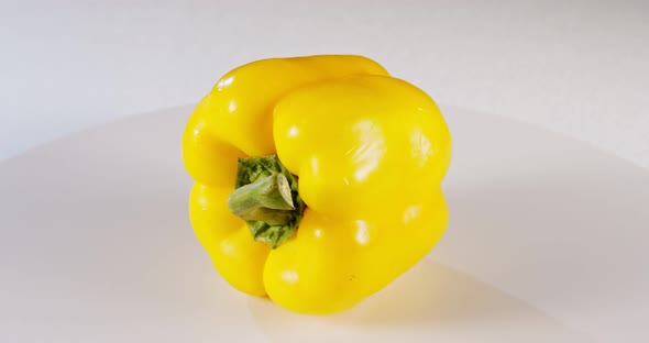 close up a yellow bell pepper rotating on a white background