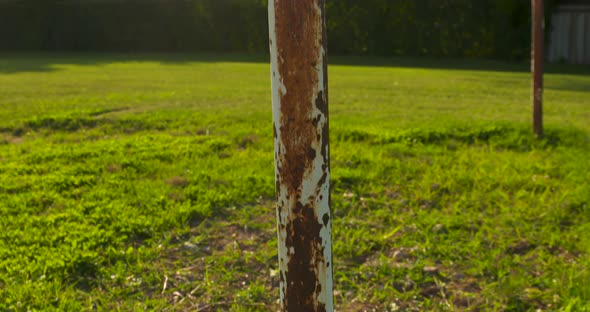 Pan up along the rusted poles of an old soccer goalpost