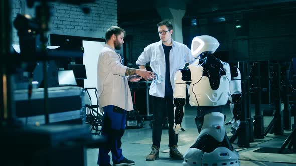 Two Specialists and a Robot in a Laboratory
