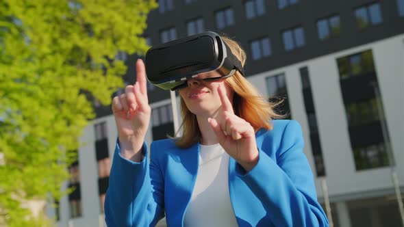 Woman Touching the Air and Open the Windows with Her Finger in Virtual Reality Glasses