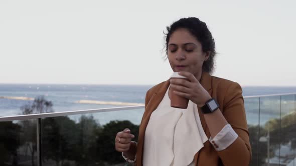 Young Fashionable Entrepreneur Woman Drinking Coffee and Walking To Work