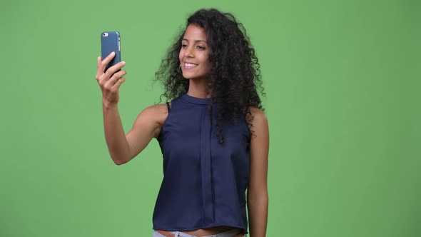 Young Beautiful Hispanic Businesswoman Using Phone