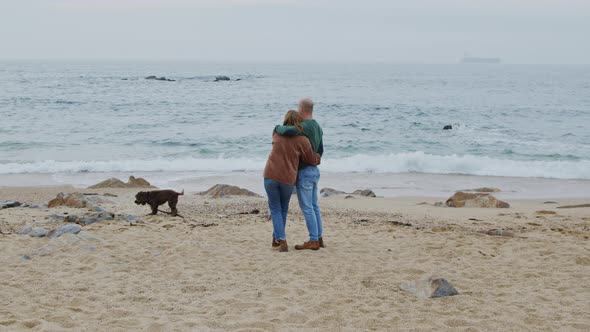 Young Couple Standing On Ocean Coast