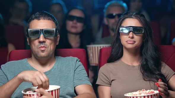 Closeup Excited Couple Watching Movie Premiere Action Showtime Wearing 3d Glasses Eating Popcorn