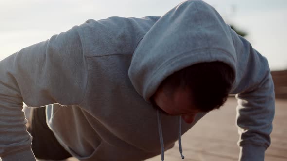 Sportsman Is Doing Pushups on Street During Morning Work Out