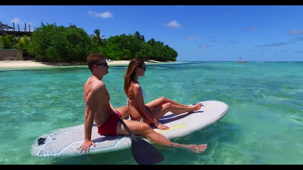 Teenage lovers suntan on paradise sea view beach holiday by transparent ocean and white sand backgro