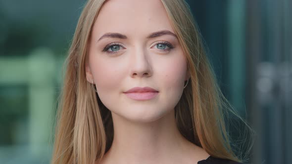 Portrait of Smiling Confident Whiteskinned European Caucasian Millennial Woman on Blue Background