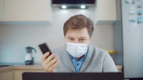 Angry Man in Medical Mask Talking on Video Link