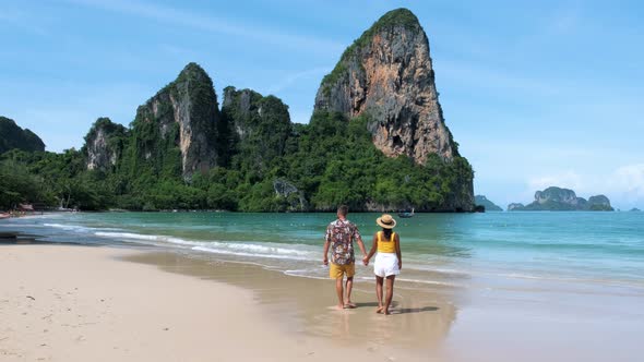 Railay Beach Krabi Thailand Couple Asian Woman and European Men Walking on the Tropical Beach of