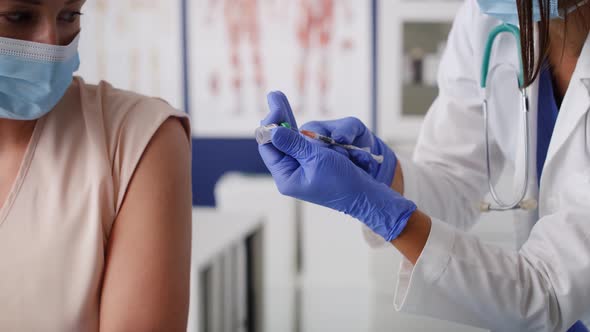 Video of doctor vaccinates a patient in a doctor's office. Shot with RED helium camera in 8K.