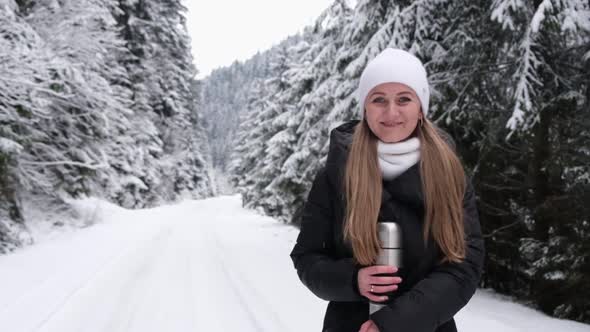 The Girl Holds the Snow in Her Hands and Blows It She Has Fun in the Winter Forest