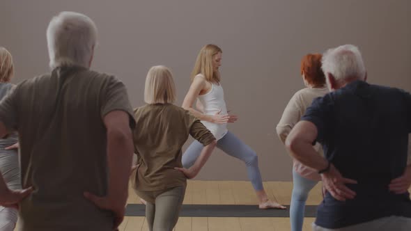 Woman Teaching Yoga to Seniors