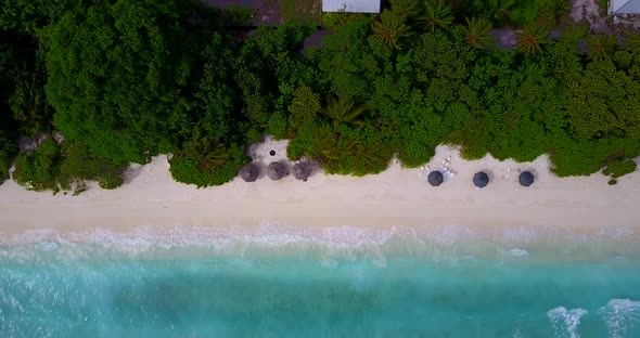 Daytime drone tourism shot of a summer white paradise sand beach and aqua blue ocean background in b