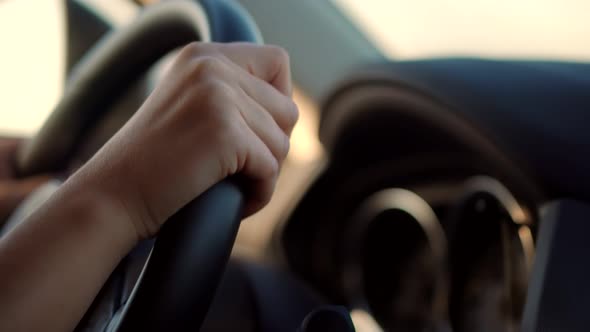 Woman Driver Hand On Car Steering Wheels. Using Windshield Wiper And Washer Controls In Car.