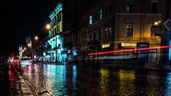 Timelapse Movement of Cars on Narrow Cobbled Road. Night City Life. Traffic Light. Vehicles with