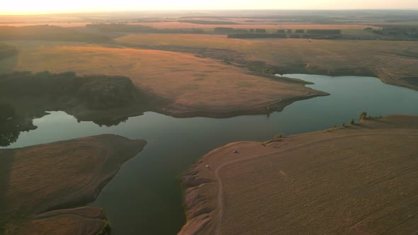 Aerial View of a Beautiful Lake Green Summer Forest and Field