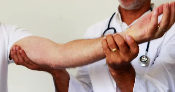 Doctor helping his patient to do exercises