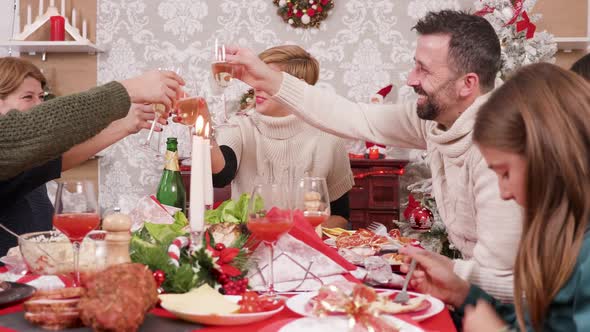 Big Family Making a Toast and Clinking Glasses of Champagne