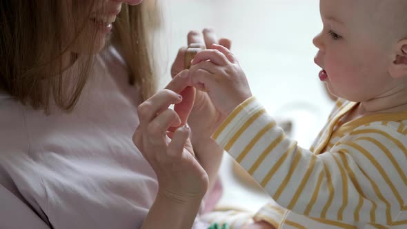 Little Baby Girl and Mommy Playing Wooden Eco Toys at Home