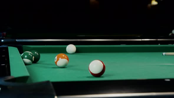 Balls Falling Into Pockets On A Billiard Table