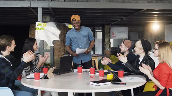 Creative Developers Applauding Their Afro-American Colleague Who Presented Diagram on Glass Board