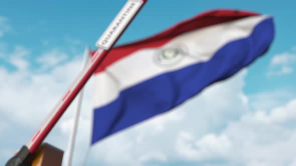 Barrier with QUARANTINE Sign Being Closed at Flag of Paraguay