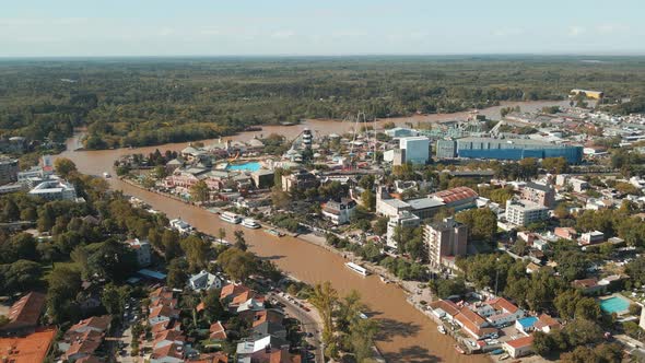 Aerial establishing shot of Tigre river mouth flying towards Paraná delta. Dolly in