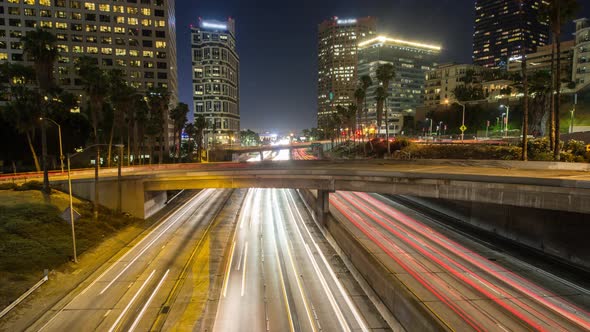 A cityscape time lapse in downtown Los Angeles. Busy night traffic across freeway I-110 shot from We