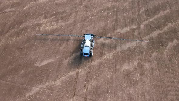 Aerial Drone Shot of a Farmer Spraying Soybean Fields