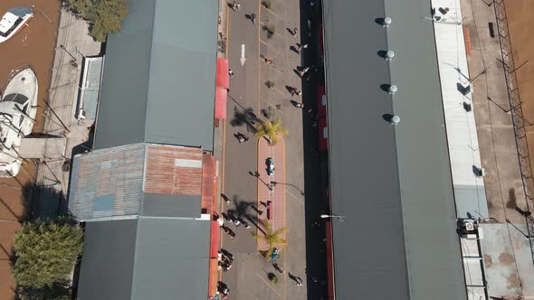 Aerial tilt reveal shot of Puerto de Frutos, a touristic market in Tigre city, near Buenos Aires