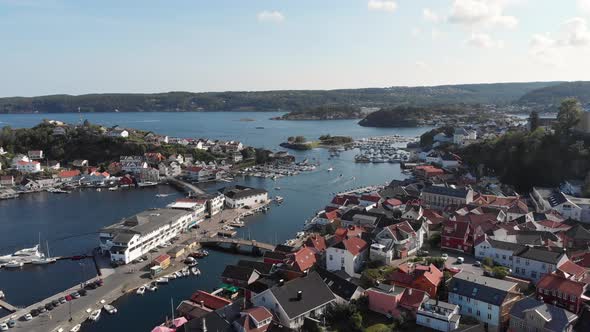 Aerial flight above Kragero town centre showing the docs and surrounding islands, Norway