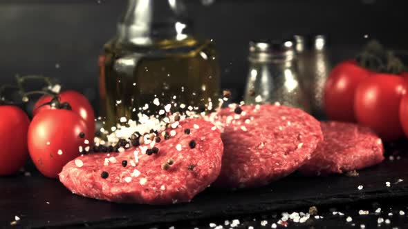 Super Slow Motion Salt and Pepper Falls on the Raw Burger