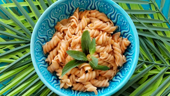 Bowl Of Macaroni Rotating On Green Leaves