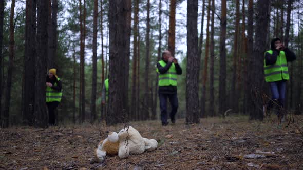 Group of Volunteers in Green Vests Went in Search of Missing Persons in a Pine Forest